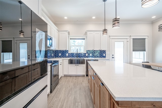 kitchen with black range with electric stovetop, white cabinetry, dishwasher, decorative light fixtures, and ornamental molding