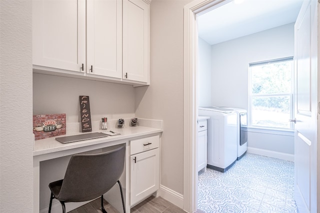 clothes washing area featuring washer and dryer and cabinets