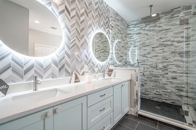 bathroom with tile patterned floors, vanity, and tile walls