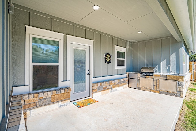 entrance to property with area for grilling, sink, and a patio