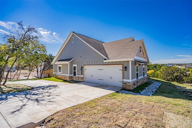 view of side of home featuring a lawn and a garage