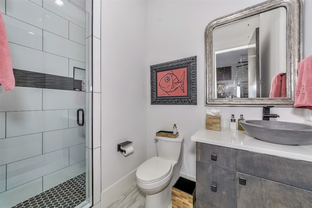 bathroom with an enclosed shower, vanity, hardwood / wood-style floors, and toilet