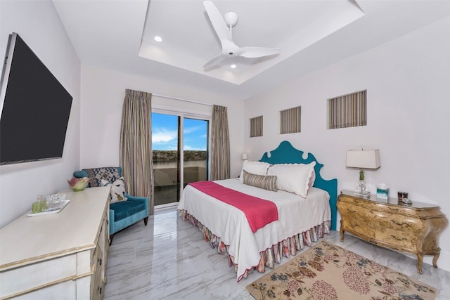 bedroom featuring a tray ceiling, light tile floors, ceiling fan, and access to outside