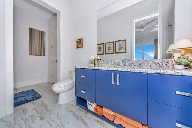 bathroom featuring vanity, tile floors, and toilet