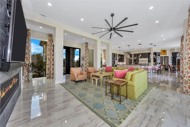 living room with light tile flooring and ceiling fan