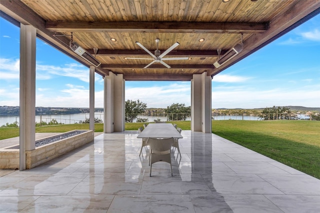 view of terrace featuring a water view and ceiling fan