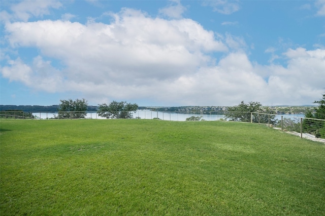 exterior space featuring a water view and a lawn