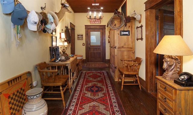 foyer entrance with dark hardwood / wood-style flooring and a chandelier