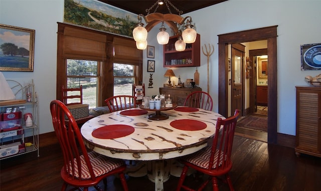 dining room featuring a notable chandelier and dark hardwood / wood-style floors