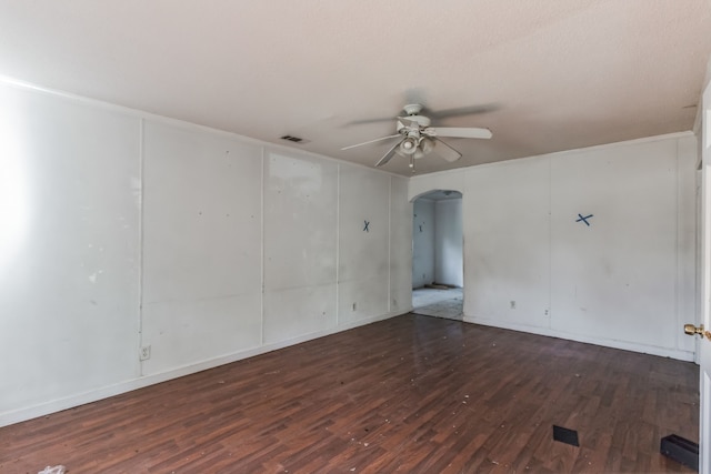 spare room with ceiling fan and dark hardwood / wood-style flooring