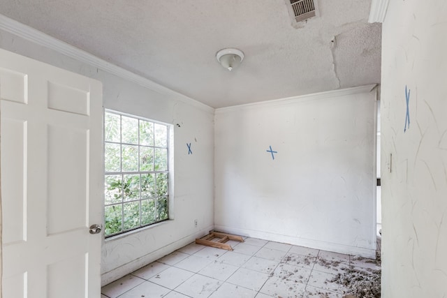 unfurnished room featuring a textured ceiling and ornamental molding