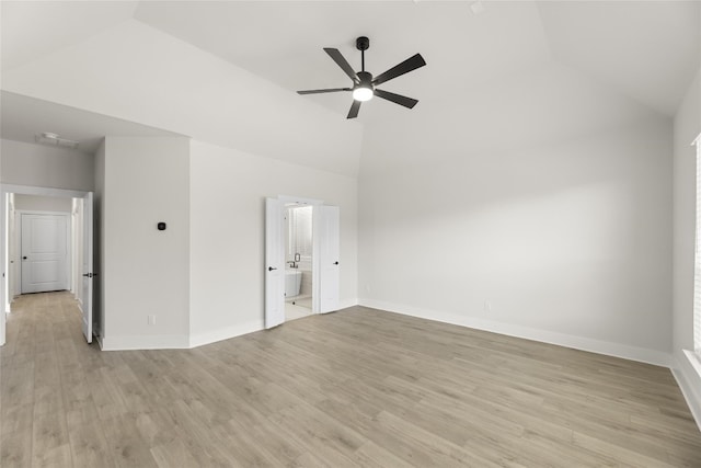 empty room with high vaulted ceiling, ceiling fan, and light wood-type flooring