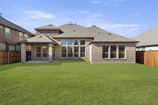 back of property with a patio and a yard