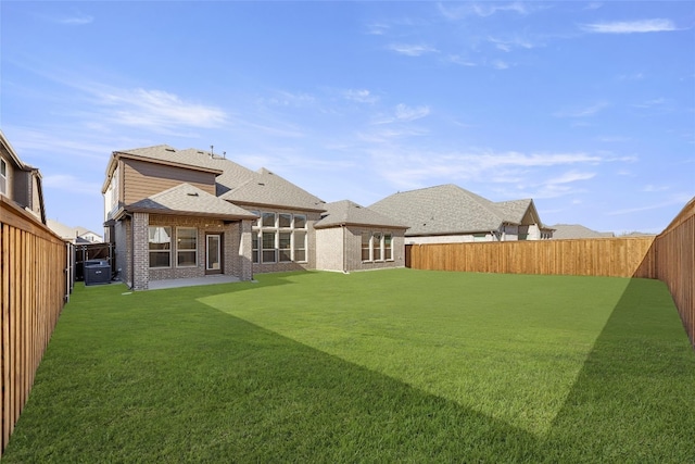 back of property featuring central AC unit, a yard, and a patio