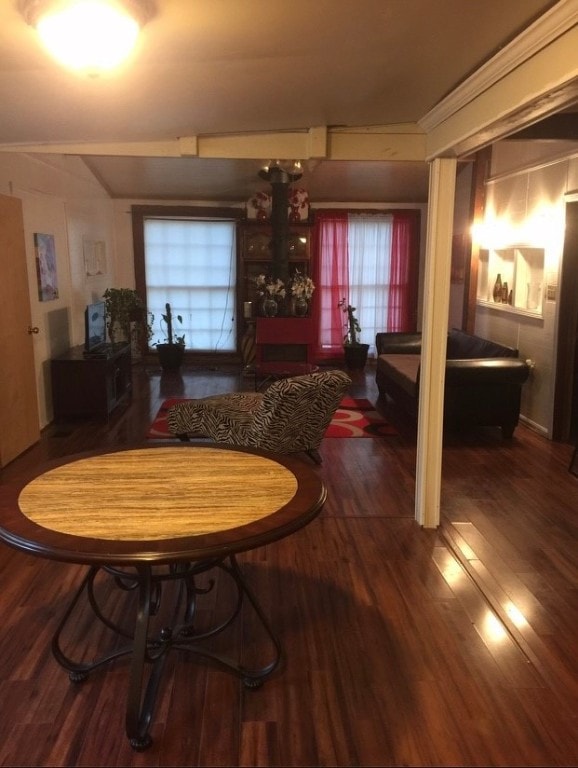 dining space featuring crown molding and dark hardwood / wood-style flooring