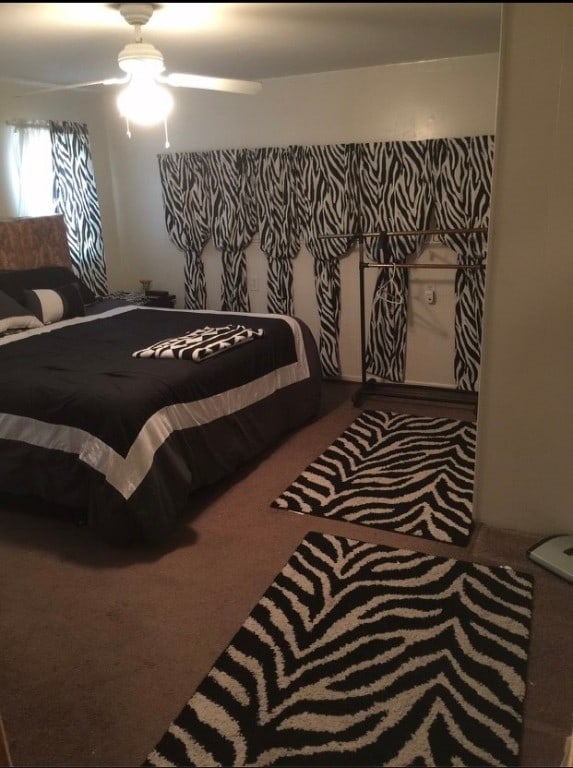 carpeted bedroom with ceiling fan