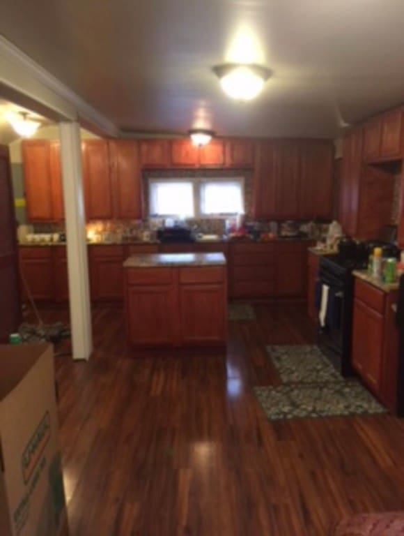 kitchen featuring dark hardwood / wood-style floors and black / electric stove