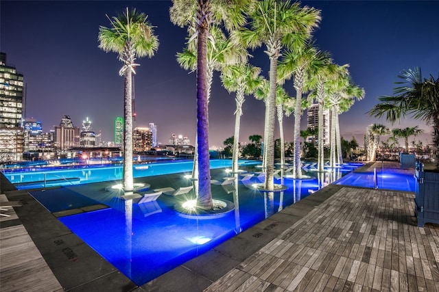 view of pool at twilight