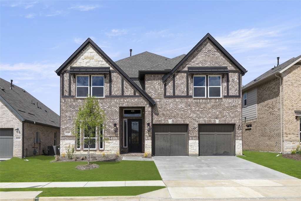 view of front of property with a front yard and a garage