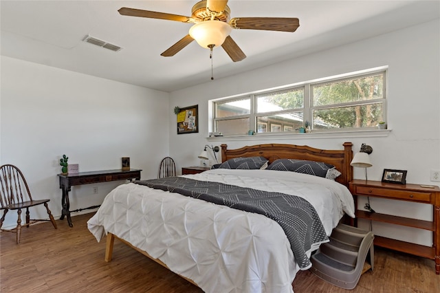 bedroom with hardwood / wood-style flooring and ceiling fan