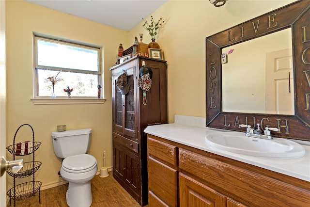 bathroom featuring hardwood / wood-style floors, oversized vanity, and toilet