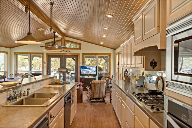 kitchen featuring a healthy amount of sunlight, appliances with stainless steel finishes, wooden ceiling, and sink