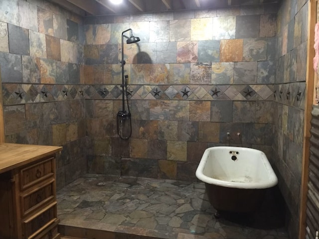 bathroom featuring tile walls, vanity, and plus walk in shower