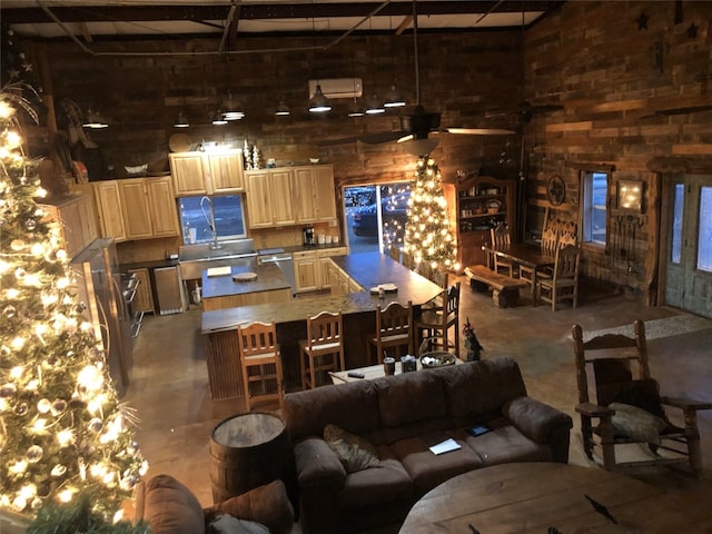 interior space featuring concrete floors, beam ceiling, and a towering ceiling