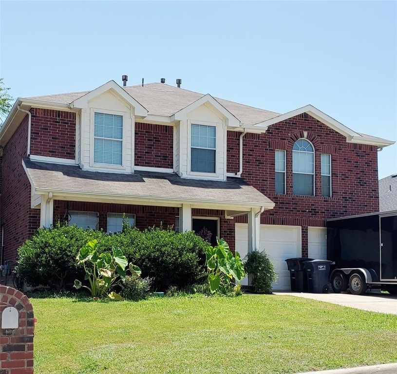 view of front of property with a front yard and a garage