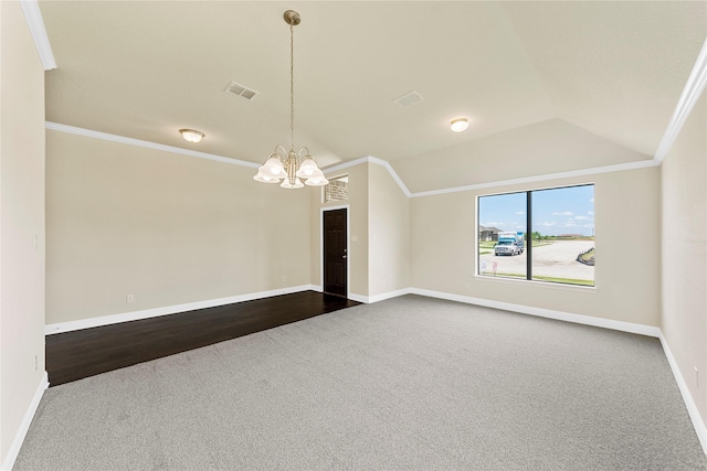 empty room with crown molding, dark wood-type flooring, vaulted ceiling, and an inviting chandelier