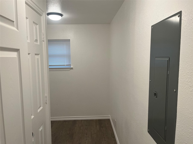 corridor with electric panel and dark hardwood / wood-style floors