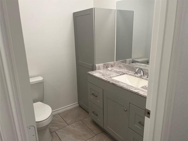 bathroom with vanity, tile patterned floors, and toilet