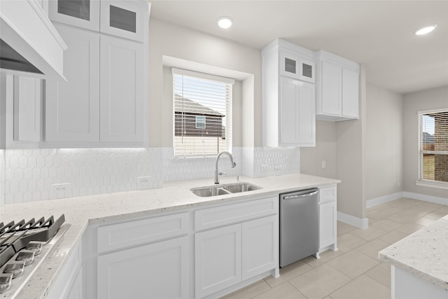 kitchen with tasteful backsplash, stainless steel appliances, white cabinets, and a wealth of natural light