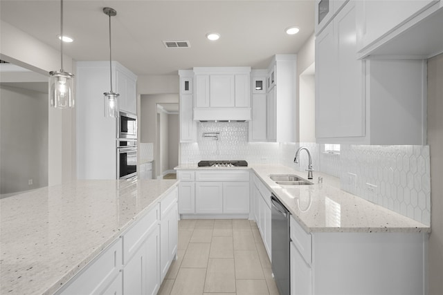 kitchen featuring sink, light stone counters, stainless steel appliances, tasteful backsplash, and white cabinetry