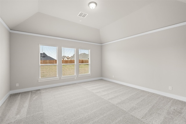 carpeted spare room with lofted ceiling and ornamental molding