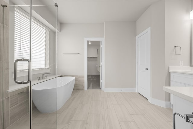 bathroom featuring vanity, tile floors, and a bathing tub