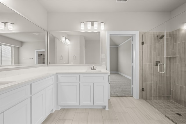 bathroom featuring dual bowl vanity, tile flooring, and walk in shower