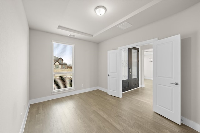 empty room with light hardwood / wood-style flooring