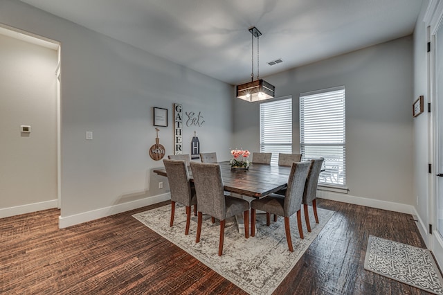 dining area with dark hardwood / wood-style flooring