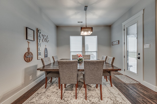 dining space with hardwood / wood-style floors