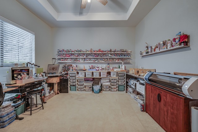 interior space featuring ceiling fan and a raised ceiling