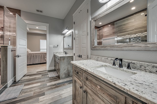 bathroom with vanity, walk in shower, and hardwood / wood-style floors