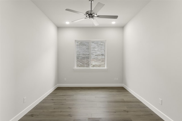 empty room featuring dark hardwood / wood-style flooring and ceiling fan