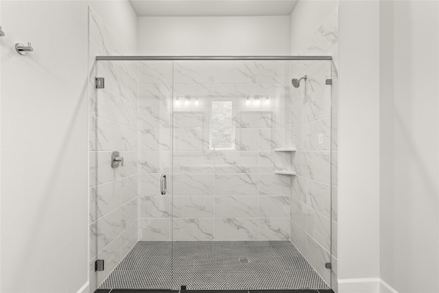 bathroom with a shower with shower door