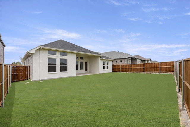 back of house featuring a lawn