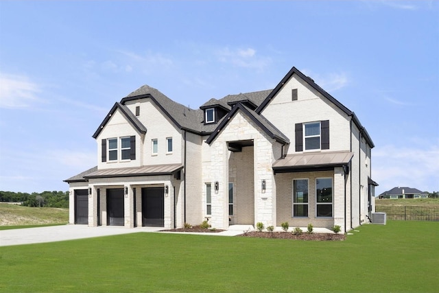 view of front of property featuring a garage, a front lawn, and central air condition unit