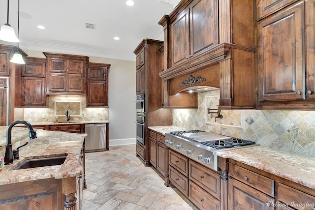 kitchen with hanging light fixtures, stainless steel appliances, backsplash, light tile floors, and sink