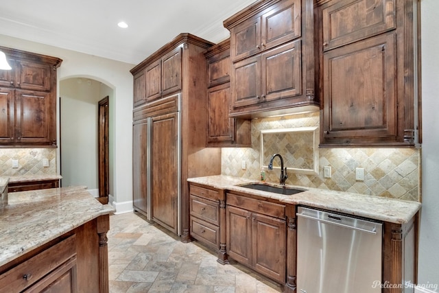 kitchen featuring stainless steel dishwasher, tasteful backsplash, light tile floors, sink, and light stone countertops