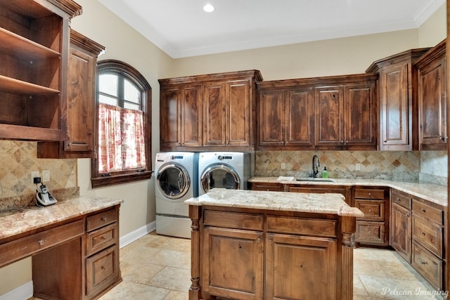 laundry area with independent washer and dryer, sink, light tile floors, ornamental molding, and cabinets