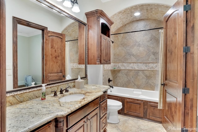 full bathroom with toilet, tile flooring, tiled shower / bath combo, and vanity